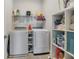 Well-equipped laundry room with modern washer, dryer, and ample storage space at 4875 Lacewing Dr, Winter Garden, FL 34787