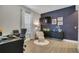 Stylish home office featuring a work desk and chair, a comfortable reading nook, and modern decor at 4875 Lacewing Dr, Winter Garden, FL 34787