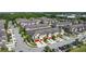 Aerial view of community townhomes, with garages, landscaping, and pond nearby at 509 Artisan St # 43, Orlando, FL 32824