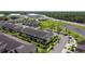 An aerial view of a residential community featuring well-maintained landscaping and a pond at 509 Artisan St # 43, Orlando, FL 32824