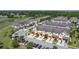 Aerial view of community townhomes, with garages, landscaping, and pond nearby at 509 Artisan St # 43, Orlando, FL 32824