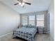 Bedroom featuring a ceiling fan, carpeted floors, and a blue and white bedspread at 509 Artisan St # 43, Orlando, FL 32824