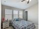 This bedroom features a ceiling fan, carpeted floors, and a blue and white bedspread at 509 Artisan St # 43, Orlando, FL 32824