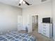 Bedroom features a ceiling fan, television, carpeted floors, and two white doors at 509 Artisan St # 43, Orlando, FL 32824