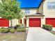 Charming townhome featuring a red garage door, tidy landscaping, and a well-maintained exterior at 509 Artisan St # 43, Orlando, FL 32824