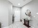 Welcoming foyer featuring neutral walls, tile flooring, and a decorative table with a round mirror at 509 Artisan St # 43, Orlando, FL 32824