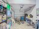 Cluttered garage with overhead door, two bicycles and household storage at 509 Artisan St # 43, Orlando, FL 32824