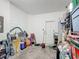 Cluttered garage with overhead door, storage bins, and household items at 509 Artisan St # 43, Orlando, FL 32824