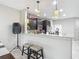 Open kitchen area with breakfast bar, granite countertops, and dark wood cabinets at 509 Artisan St # 43, Orlando, FL 32824