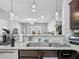 Open kitchen with granite countertops flowing into the dining and living area, perfect for entertaining at 509 Artisan St # 43, Orlando, FL 32824