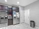 Modern kitchen with stainless steel appliances, dark wood cabinets, and easy access to the pantry at 509 Artisan St # 43, Orlando, FL 32824