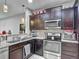 Functional kitchen layout with granite countertops, modern appliances, and convenient storage solutions at 509 Artisan St # 43, Orlando, FL 32824