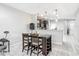 Eat-in kitchen features modern pendant lights and breakfast bar with granite countertops at 509 Artisan St # 43, Orlando, FL 32824