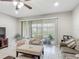 Bright living room with a ceiling fan, large sliding glass doors, and tile flooring at 509 Artisan St # 43, Orlando, FL 32824