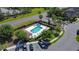 An aerial shot showcasing the community pool area, complete with lounge chairs and palm trees at 509 Artisan St # 43, Orlando, FL 32824