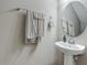 Stylish powder room features a pedestal sink and decorative wall accents at 509 Artisan St # 43, Orlando, FL 32824