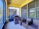 Cozy screened porch with modern patio furniture, grill and screened windows at 509 Artisan St # 43, Orlando, FL 32824