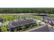 Aerial view of tan townhomes with dark roof, patios, and green space at 509 Artisan St # 43, Orlando, FL 32824