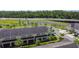 Aerial view of tan townhomes with dark roof, patios, and green space at 509 Artisan St # 43, Orlando, FL 32824