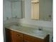 Bathroom features a double vanity with two sinks and matching mirrors, and ample storage at 5279 Images Cir # 301, Kissimmee, FL 34746