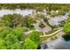 Beautiful aerial view of a home nestled among lush trees near a tranquil lake at 600 Fallsmead Cir, Longwood, FL 32750