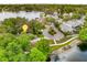 Beautiful aerial view of a home nestled among lush trees near a tranquil lake at 600 Fallsmead Cir, Longwood, FL 32750