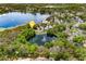 Overhead view displaying the property's location amidst a tranquil pond and lush surroundings in a residential neighborhood at 600 Fallsmead Cir, Longwood, FL 32750