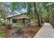 Fenced backyard with a screened gazebo featuring a hammock and a paved walkway along the home at 600 Fallsmead Cir, Longwood, FL 32750