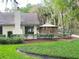 Landscaped backyard featuring a gazebo and verdant green lawn alongside the property at 600 Fallsmead Cir, Longwood, FL 32750