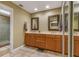 Bathroom with a double vanity, framed mirrors, and a glass-enclosed shower at 600 Fallsmead Cir, Longwood, FL 32750