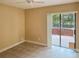 Bedroom with sliding glass doors, ceiling fan, and neutral color palette at 600 Fallsmead Cir, Longwood, FL 32750