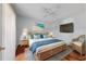 Light and airy bedroom with a woven bed frame, hardwood floors, and a mounted TV at 600 Fallsmead Cir, Longwood, FL 32750
