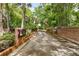 Brick community entrance surrounded by lush trees and greenery, leading to a private residential area at 600 Fallsmead Cir, Longwood, FL 32750