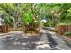 Gated community entrance with lush tropical landscaping for privacy and curb appeal at 600 Fallsmead Cir, Longwood, FL 32750