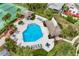 Aerial view of a sparkling community pool surrounded by lounge chairs, lush landscaping, and a covered pavilion at 600 Fallsmead Cir, Longwood, FL 32750