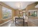 Bright dining room with large windows and a stylish chandelier, perfect for entertaining guests at 600 Fallsmead Cir, Longwood, FL 32750