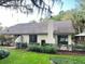 Home exterior with neatly manicured landscaping, a chimney, and hints of a gazebo in the backyard at 600 Fallsmead Cir, Longwood, FL 32750