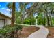 Scenic view of the property's grounds, featuring a paved pathway leading to a fountain and serene pond at 600 Fallsmead Cir, Longwood, FL 32750