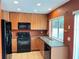 Modern kitchen showcasing light-colored cabinets, sleek appliances, and granite countertops at 600 Fallsmead Cir, Longwood, FL 32750