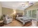 Cozy main bedroom with a soft rug, armchair, and bedside tables, providing a peaceful retreat at 600 Fallsmead Cir, Longwood, FL 32750