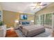 Serene main bedroom featuring a comfortable bed, soft lighting, and a sliding glass door at 600 Fallsmead Cir, Longwood, FL 32750