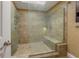 Large tiled walk-in shower with multiple shower heads and a built-in bench at 600 Fallsmead Cir, Longwood, FL 32750