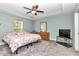 Spacious bedroom boasts a tray ceiling, ceiling fan, and plenty of natural light at 6144 Avenue G, Mc Intosh, FL 32664
