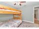 Cozy bedroom featuring a bunkbed, ceiling fan, and carpeted floor at 6144 Avenue G, Mc Intosh, FL 32664