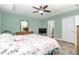 Bright bedroom features a ceiling fan and an ensuite bathroom at 6144 Avenue G, Mc Intosh, FL 32664