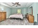 Comfortable bedroom with a tray ceiling, a ceiling fan, and an abundance of natural light at 6144 Avenue G, Mc Intosh, FL 32664