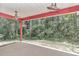 Covered patio with ceiling fans and expansive views of the wooded backyard at 6144 Avenue G, Mc Intosh, FL 32664