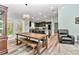 Elegant dining area showcasing wood flooring, pendant lighting, and a view into the kitchen at 6144 Avenue G, Mc Intosh, FL 32664