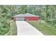Exterior view of the home, long driveway, surrounded by trees, and freshly manicured lawn at 6144 Avenue G, Mc Intosh, FL 32664