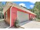 Side view of garage with traditional panel door, side window, and house number at 6144 Avenue G, Mc Intosh, FL 32664